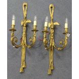 A pair of late 19th Century gilt cast bronze twin branch wall lights, each tassel effect back