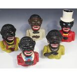 Three cast metal novelty money boxes in the form of jolly black men, one wearing a white top hat,