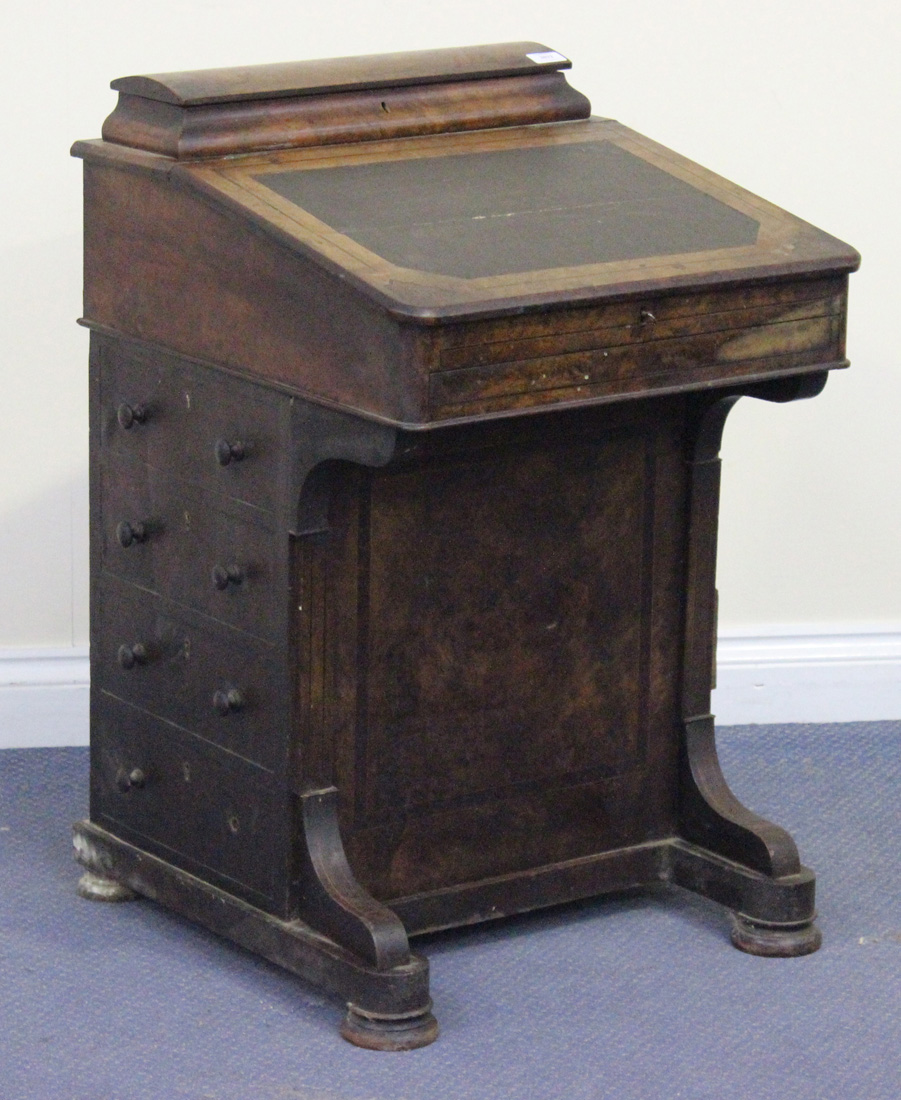 A Victorian burr walnut Davenport with inlaid decoration, the pen compartment above a hinged writing