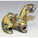 A Chinese gilt bronze scroll weight, possibly 17th Century, modelled as a chimera standing four