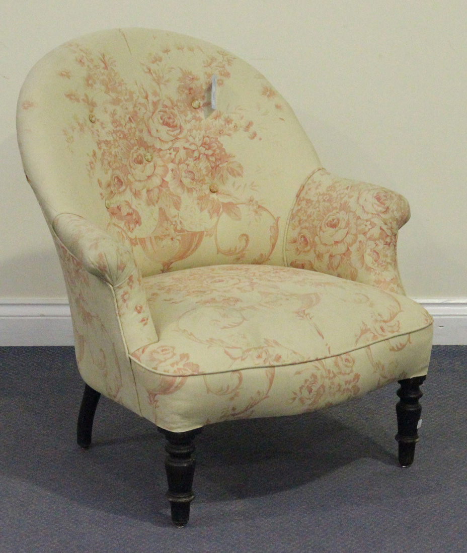 A late Victorian tub back armchair, raised on ebonized turned tapering legs, height approx 81cm,