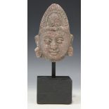 A Chinese carved stone Buddha head, mounted on an ebonized plinth, total height approx 25cm.