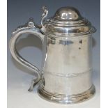 A George II silver tankard with domed hinge cover, scroll thumbpiece and scroll handle with heart