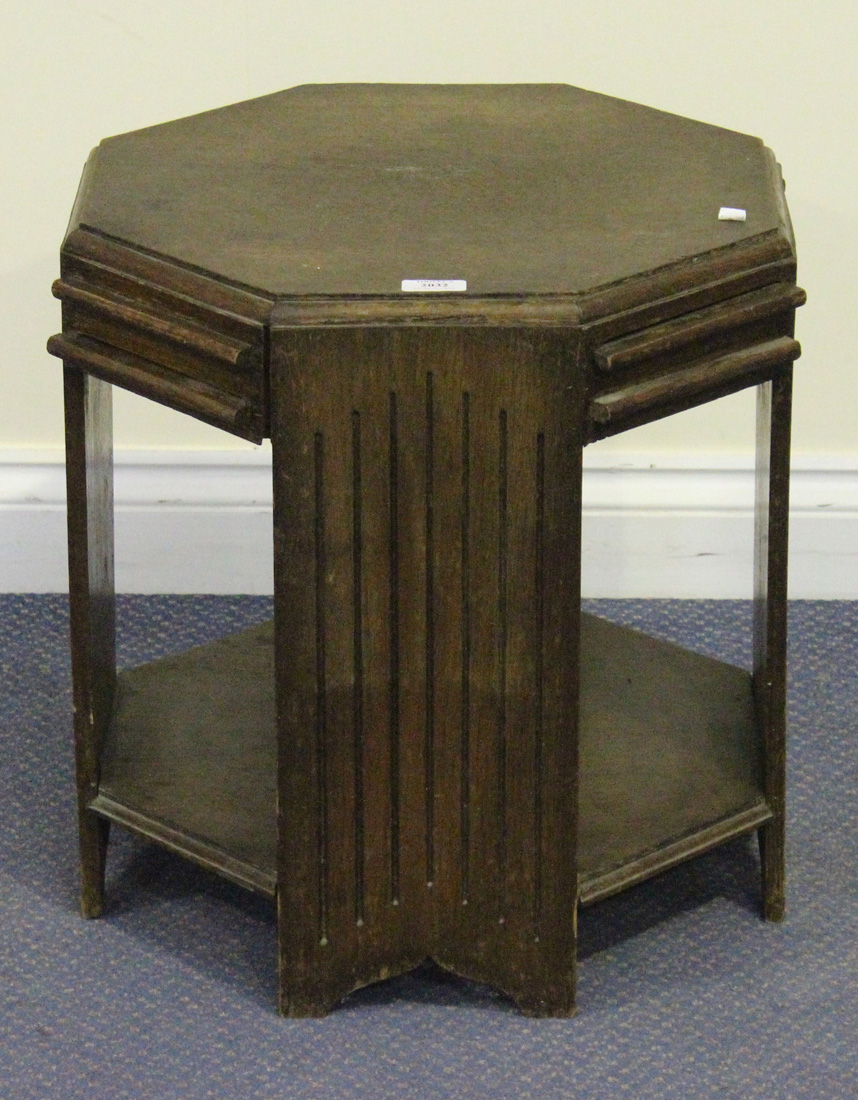 An Art Deco style oak octagonal occasional table, the frieze fitted with four pull-out slides