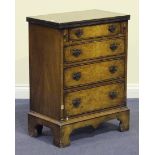 A 20th Century reproduction walnut bachelor's chest, the hinged top above four drawers, on bracket