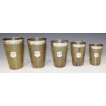 A harlequin set of five Victorian silver mounted horn interfitting beakers, each with silver rim and