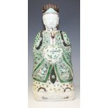 A Chinese famille verte enamelled biscuit porcelain figure of a seated scholar, probably Kangxi