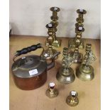 A small collection of copper and brassware, including a warming pan, a kettle, candlesticks and