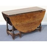 A 17th Century oak oval gateleg table, raised on turned and block legs united by stretchers,