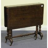 A Victorian walnut Sutherland table, on turned supports and outswept feet, terminating in brass caps