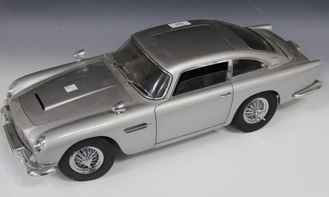 A 1:8 scale replica model of James Bond's Aston Martin DB5, together with related magazine issues. - Image 3 of 5
