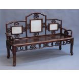 A Chinese rosewood bench, late 19th/early 20th Century, the shaped arched trellis back with three