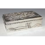 A Japanese silver cigarette box of rectangular form, the hinged lid decorated in relief with a