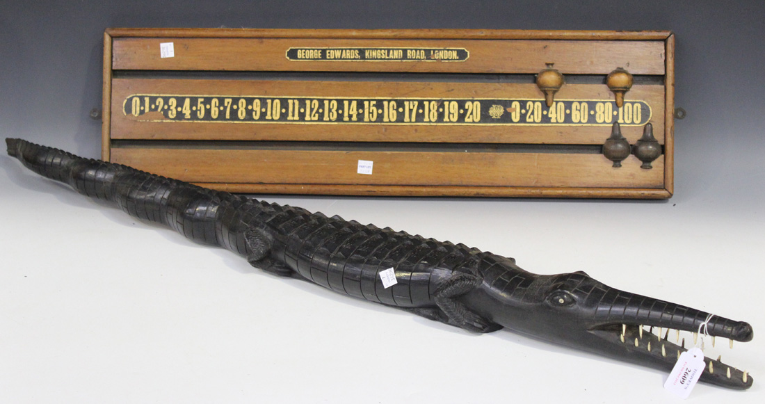 A 20th Century African carved hardwood model of a crocodile, length approx 102cm, together with a