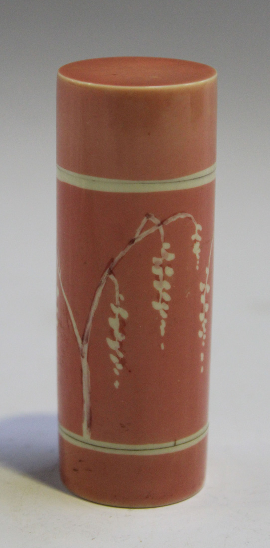 An Art Deco stained pink ivorine cylindrical nécessaire, the body decorated with a lady standing