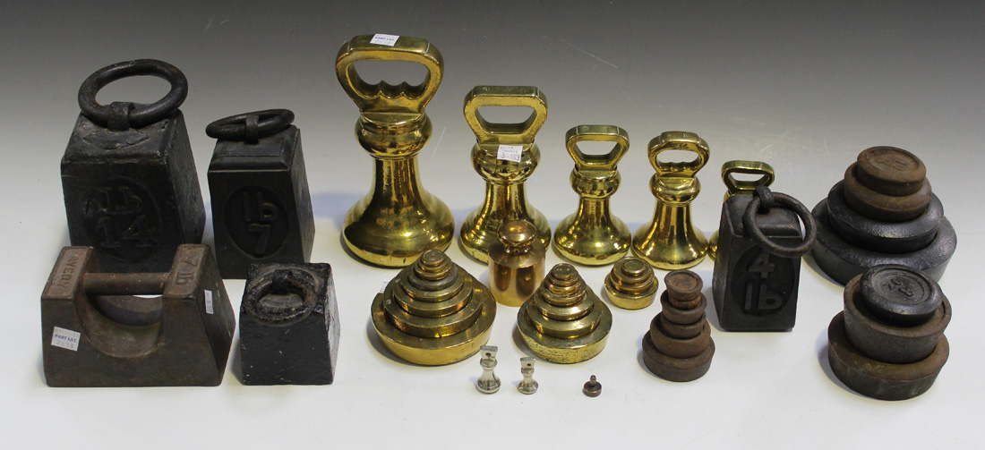 A collection of late 19th and early 20th Century brass and cast iron kitchen weights.