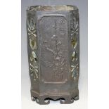 A Chinese bronze brush pot, late Qing dynasty, the sides cast with panels representing the four