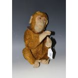 An early 20th Century mohair monkey with amber and black eyes, felt face and hands, and jointed