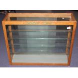 A Dinky Toys oak glazed shop display cabinet, fitted with four shelves and frosted glass doors,