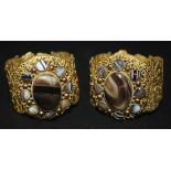 A pair of gilt metal and banded agate oval hinged bangles, probably Italian mid-19th Century, each