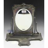 An early 20th Century Orivit pewter swing frame dressing table mirror, the oval mirror within a