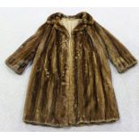 A mid-20th Century brown fur three-quarter length coat with brown fabric lining, length approx