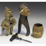 Two Black Forest carved softwood novelty nutcrackers, a 19th Century crossbar corkscrew, stamped '