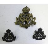 A scarce Hong Kong Defence Force cap badge by Firmin, cast with a crown above two dragons and