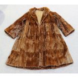 A mid-20th Century brown fur three-quarter length coat with brown fabric lining, length approx