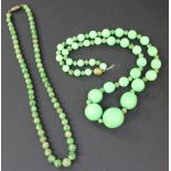 A single row necklace of slightly graduated jade beads on a base metal clasp, and a single row
