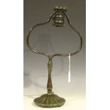 A Tiffany Studios patinated cast bronze table lamp, the domed circular base marked to the