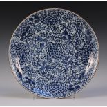 A Chinese blue and white porcelain circular dish, Kangxi period, painted with a design of dense