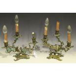 A pair of French Louis XV style gilt metal triple light candelabra with porcelain mounted branches