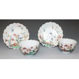 A pair of Chinese famille verte porcelain teabowls and stands, Kangxi period, each of lobed circular