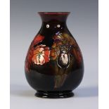 A Moorcroft flambé pottery vase, circa 1950s, of ovoid form with narrow neck decorated with Orchid