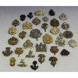A collection of cap badges, including 3rd Gloucestershire Vol., London Rifle Brigade, XIX County