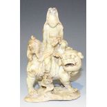 A Chinese green soapstone carving, 20th Century, modelled as Guanyin seated on the back of a