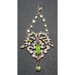 A silver, green, red and colourless paste set pendant in a bow and foliate design, the front with