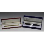 A Must de Cartier gold plated ballpoint pen, impressed '905546', cased, together with a Waterman