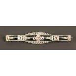 A diamond set brooch, pierced in a geometric Art Deco design, mounted with three principal cushion