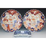 A pair of Japanese Imari porcelain circular dishes, Meiji period, each painted with a dragon and