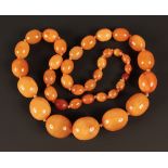 A single row necklace of thirty-eight graduated oval semi-translucent and opaque mottled
