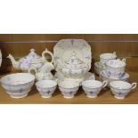 A Staffordshire part tea service, 19th Century, with lilac relief moulded decoration, comprising