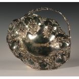 A William IV silver fruit basket of lobed circular form with pierced foliate scroll swing handle,