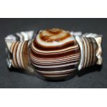 A banded agate bracelet, the principal circular agate between shaped rectangular agate beads,