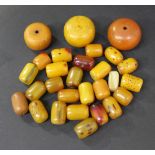 Six treated translucent amber beads, a quantity of disc shaped translucent amber beads and a