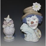 A Lladro porcelain bust of a clown, Melancholy, No 5542 (two petals broken), together with a