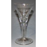 A wine glass, mid-18th Century, with drawn trumpet bowl, on a teared plain stem and conical foot,