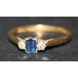 A gold, platinum, sapphire and diamond three stone ring, claw set with the rectangular step cut