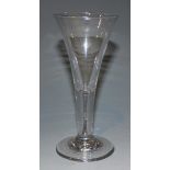 A wine glass, mid-18th Century, with drawn trumpet bowl, on a plain stem and circular foot, height